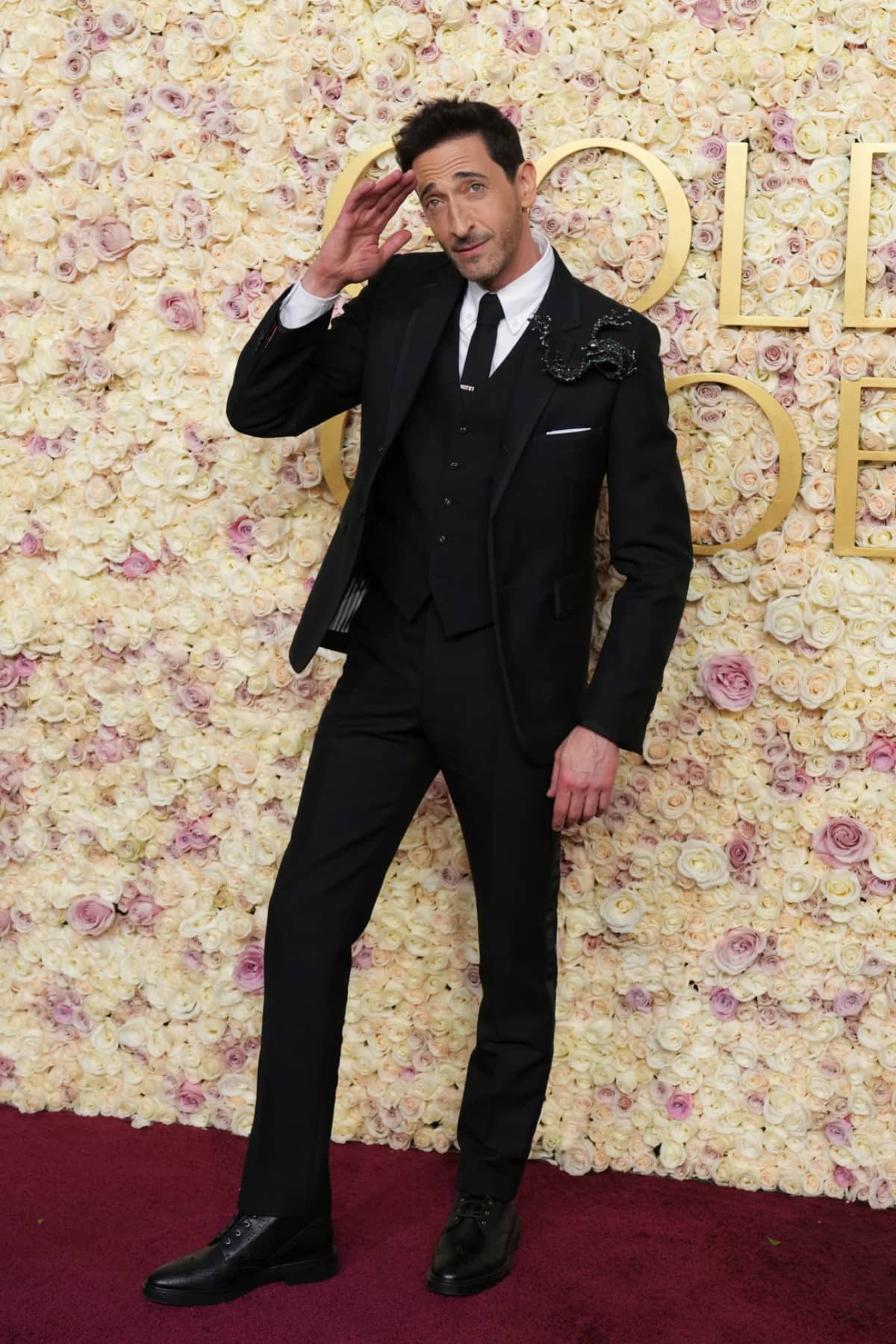 Adrien Brody wore a three-piece Thom Browne tuxedo adorned with a large brooch