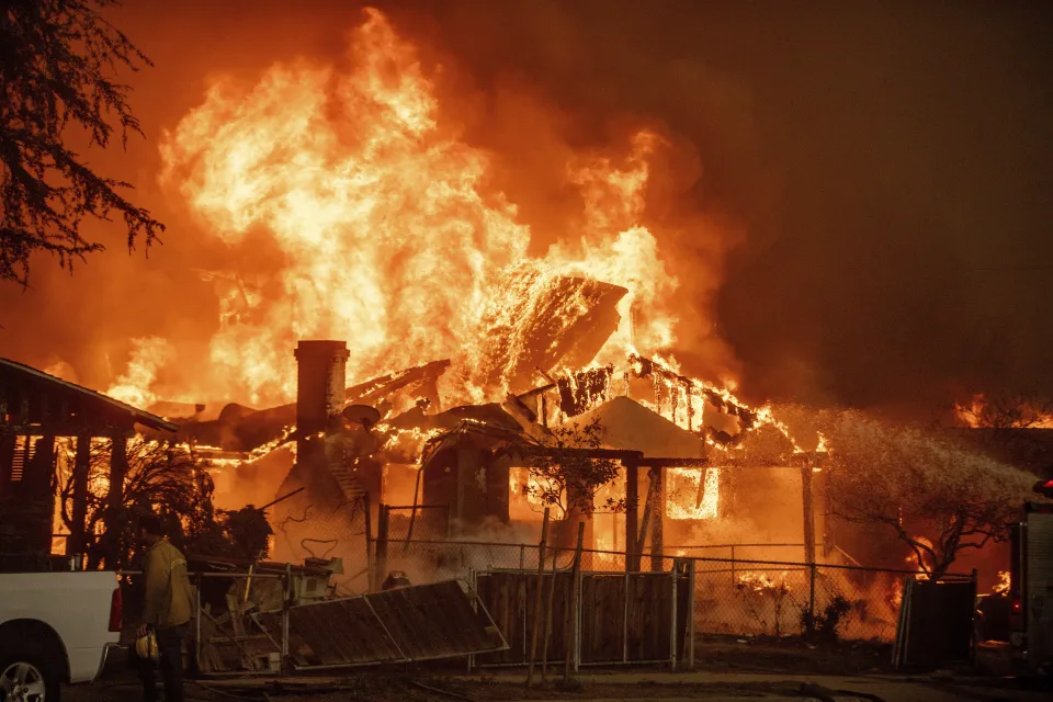 The Eaton Fire burns a structure Jan. 8 in Altadena Calif. AP Photo Ethan Swope