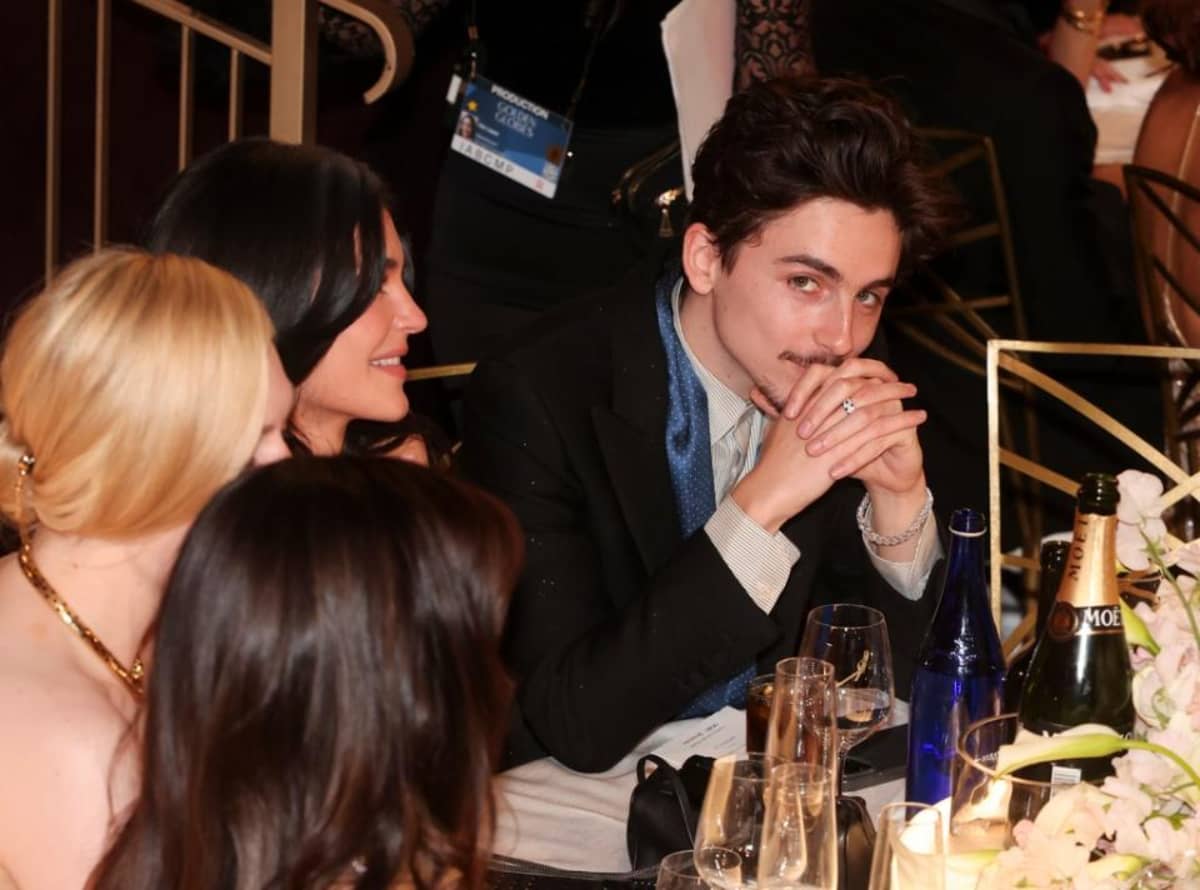 Timothée Chalamet is every guy sitting with his girlfriend while she's chatting away with her pals