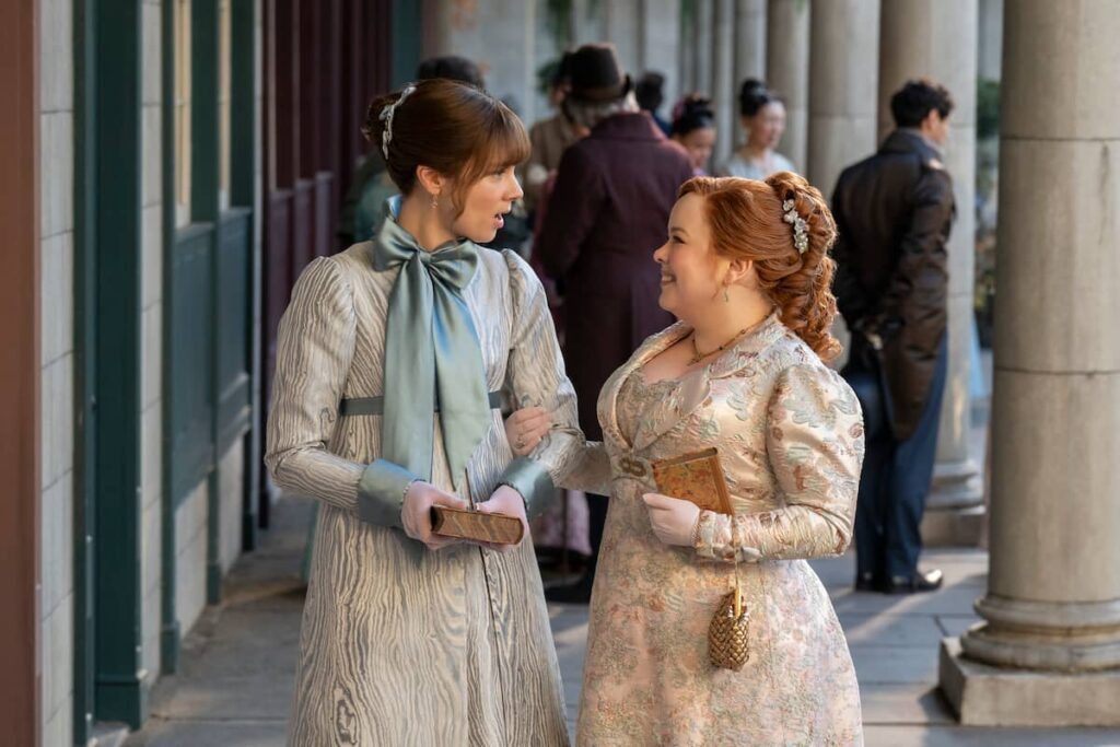 Netflix Delays Bridgerton Season 4 to 2026 – Here’s Your First Look 2 Claudia Jessie as Eloise Bridgerton and Nicola Coughlan as Penelope Featherington in Bridgerton Season 4.