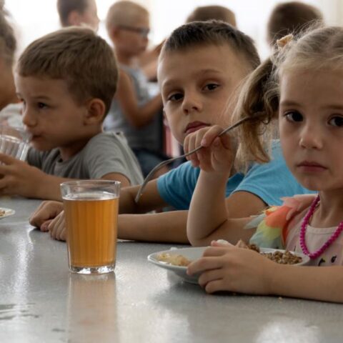 Experts Say Russia’s Mass Abduction of Ukrainian Children Is a War Crime As many as 35,000 Ukrainian children are missing and believed to be held in Russia or areas controlled by Russia, according to experts from Yale University. Families are taking desperate steps to try to bring their children back. Since Russia’s invasion began in February 2022, children have been taken from care homes, battlefields, and even directly from their families. Russia denies demands to return the children and claims Ukraine is “staging a show” about the issue. One mother, Natalia, shared how she rescued her two sons from a children’s camp in Russia after months of being separated. She traveled alone for six days through checkpoints before reuniting with them. The Yale team calls this the largest child abduction in war since World War II, comparing it to Nazi Germany’s forced Germanification of Polish children. Only 1,366 children have so far been returned or escaped. Many children are placed in military camps, foster care, or adopted by Russian families. Rescued children describe being punished for speaking Ukrainian and forced to learn Russian symbols and anthems. Experts warn that if children are placed in orphanages or adopted, it becomes nearly impossible to bring them back to Ukraine. The international criminal court agrees these actions are war crimes. In March 2023, it issued arrest warrants for Russian President Vladimir Putin and children’s commissioner Maria Lvova-Belova for unlawfully deporting Ukrainian children. Ukraine demands the return of all abducted children in any peace talks. Experts say Russia is using the children as bargaining chips in negotiations.
