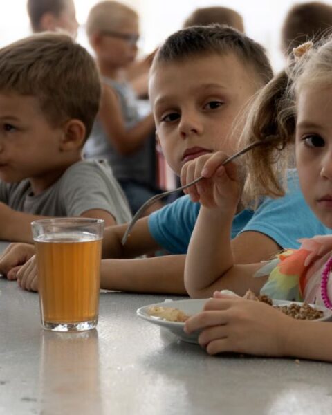 Experts Say Russia’s Mass Abduction of Ukrainian Children Is a War Crime As many as 35,000 Ukrainian children are missing and believed to be held in Russia or areas controlled by Russia, according to experts from Yale University. Families are taking desperate steps to try to bring their children back. Since Russia’s invasion began in February 2022, children have been taken from care homes, battlefields, and even directly from their families. Russia denies demands to return the children and claims Ukraine is “staging a show” about the issue. One mother, Natalia, shared how she rescued her two sons from a children’s camp in Russia after months of being separated. She traveled alone for six days through checkpoints before reuniting with them. The Yale team calls this the largest child abduction in war since World War II, comparing it to Nazi Germany’s forced Germanification of Polish children. Only 1,366 children have so far been returned or escaped. Many children are placed in military camps, foster care, or adopted by Russian families. Rescued children describe being punished for speaking Ukrainian and forced to learn Russian symbols and anthems. Experts warn that if children are placed in orphanages or adopted, it becomes nearly impossible to bring them back to Ukraine. The international criminal court agrees these actions are war crimes. In March 2023, it issued arrest warrants for Russian President Vladimir Putin and children’s commissioner Maria Lvova-Belova for unlawfully deporting Ukrainian children. Ukraine demands the return of all abducted children in any peace talks. Experts say Russia is using the children as bargaining chips in negotiations.