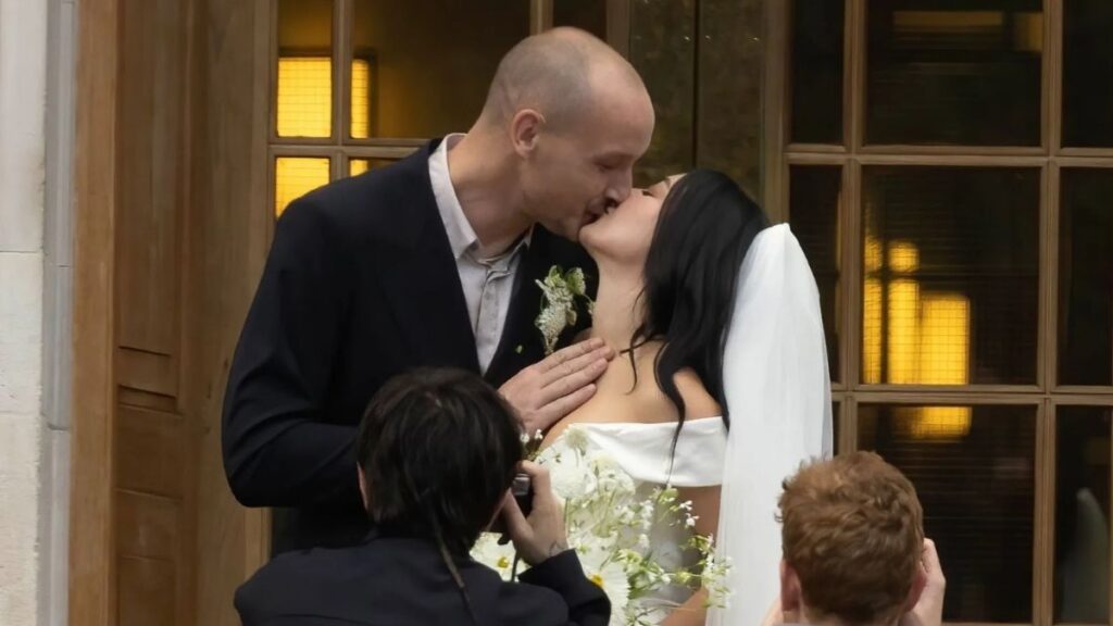 George Daniel and Charli xcx kiss at their wedding in London on July 19, 2025.
