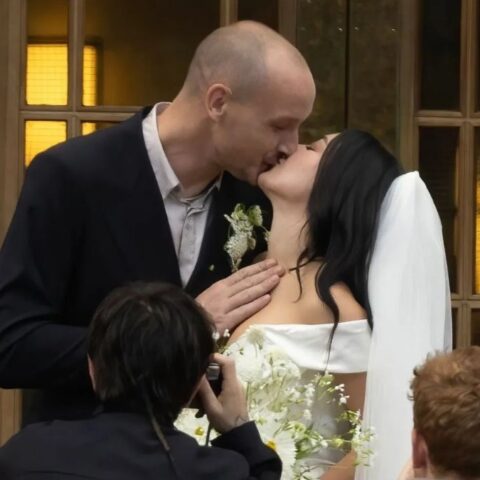 George Daniel and Charli xcx kiss at their wedding in London on July 19, 2025.