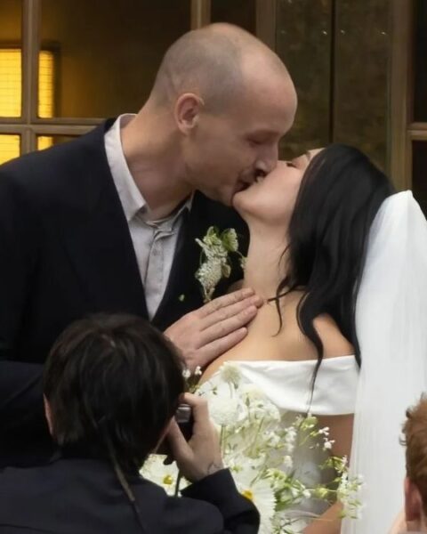 George Daniel and Charli xcx kiss at their wedding in London on July 19, 2025.