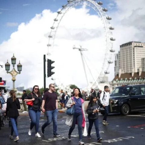 People walk over Westminster Bridge in London