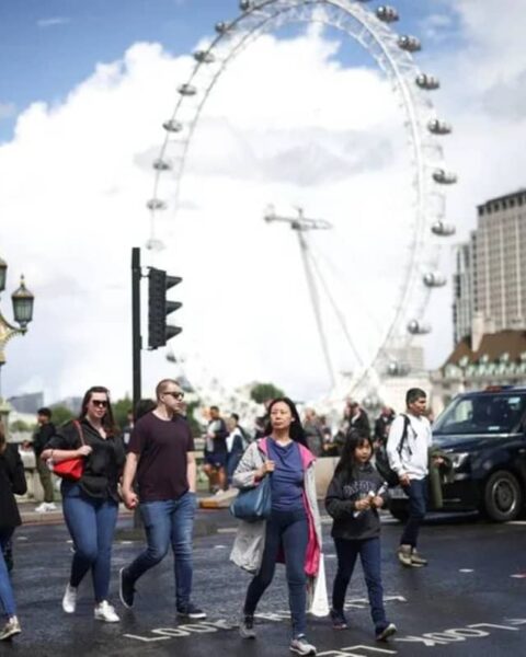People walk over Westminster Bridge in London