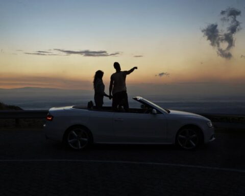 Couple Besides A Car