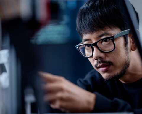 Guy Sitting Infront & Looking At a Computer