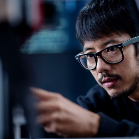 Guy Sitting Infront & Looking At a Computer