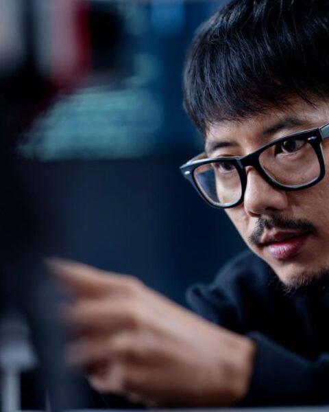 Guy Sitting Infront & Looking At a Computer