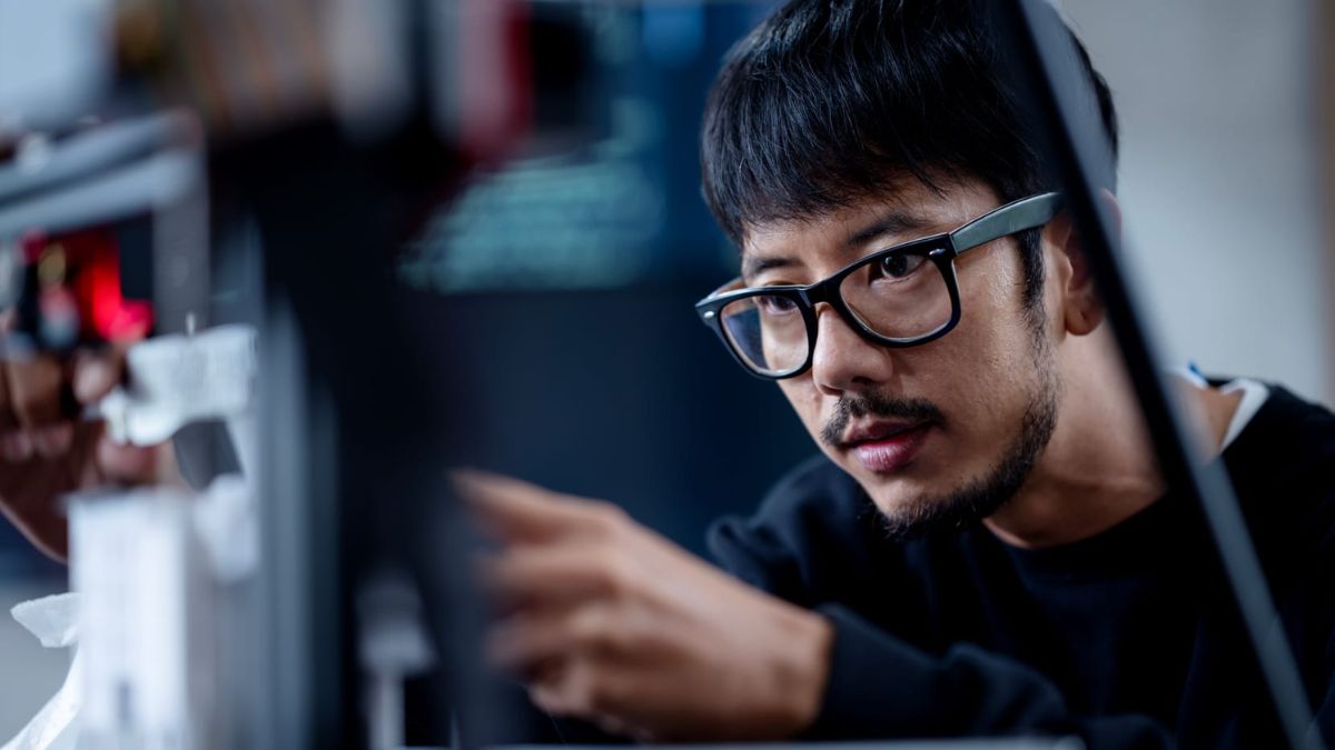 Guy Sitting Infront & Looking At a Computer
