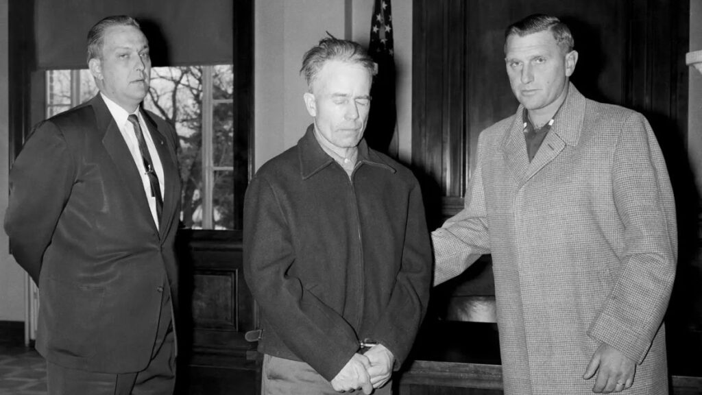 Ed Gein stands with his attorney at the Wabsara County Court.