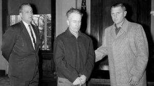 Ed Gein stands with his attorney at the Wabsara County Court.