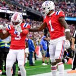 DeMario Douglas #3 of the New England Patriots celebrates with teammate Ja'Lynn Polk #1 after scoring a touchdown against the Houston Texans