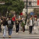 Pedestrians cross a road in the Xintiandi shopping area in Shanghai.