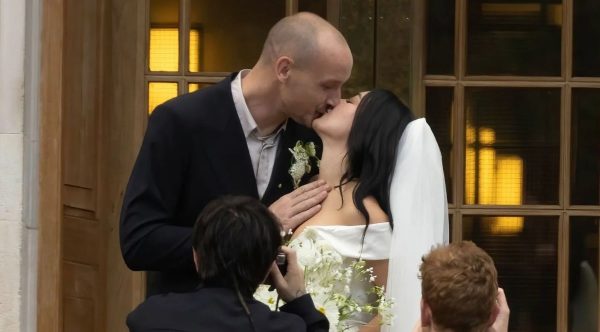 George Daniel and Charli xcx kiss at their wedding in London on July 19, 2025.