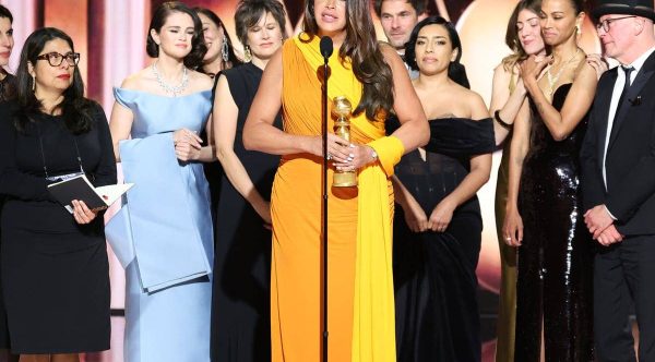 The actress Karla Sofía Gascón, center, accepts the best picture, musical or comedy award for “Emilia Pérez”